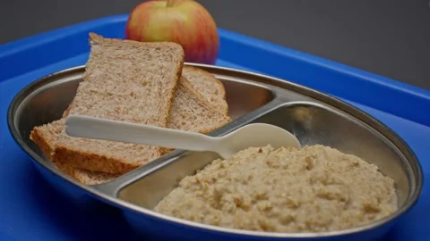 Basic Oatmeal and Bread Prison Rations Served on a Plastic Tray Stock Footage 231908965