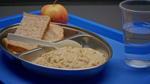 Basic Oatmeal and Bread Prison Rations Served on a Plastic Tray Stock Footage 231909181