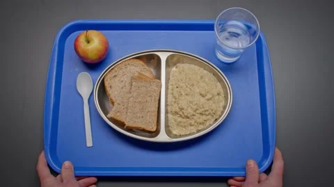 Basic Oatmeal and Bread Prison Rations Served on a Plastic Tray Stock Footage 231913852