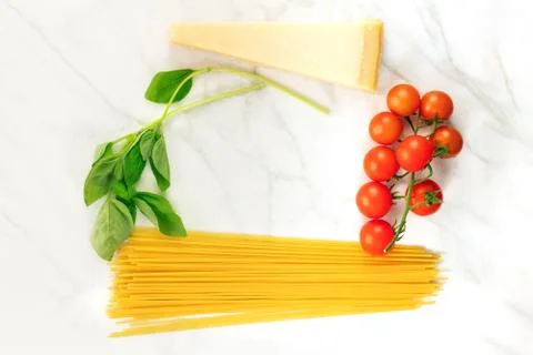 Basic pasta ingredients, including spaghetti and cheese Stock Photos