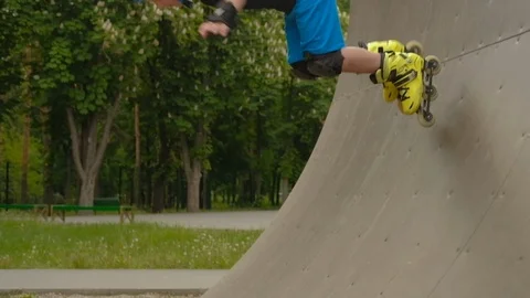 Basic ramp training roller boy achieving momentum Stock Footage 111333802