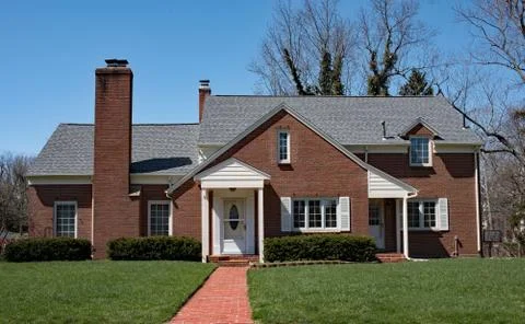 Basic Red Brick Home with Long Brick Walk Stock Photos