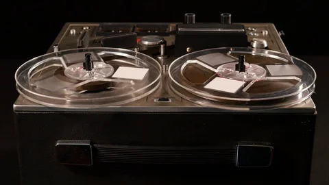 Basic Reel to Reel Tape recorder playing music Video stock 86558399