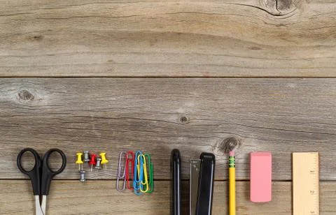 Basic school or office supplies on rustic wooden boards Stock Photos