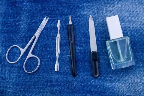 Basic set of manicure tools on jeans background Stock Photos