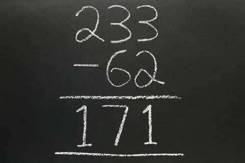 A basic subtraction sum written on a blackboard. Photos