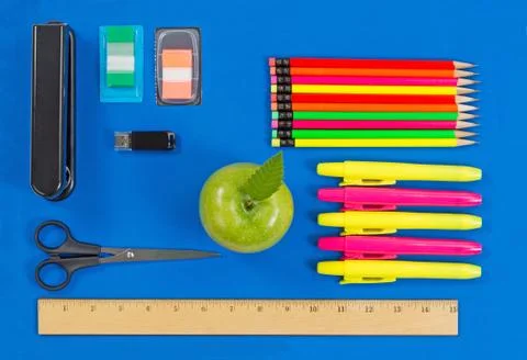 Basic supplies for office or back to school on blue background Stock Photos