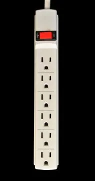 A basic surge protector electric outlet isolated on black background Stock Photos
