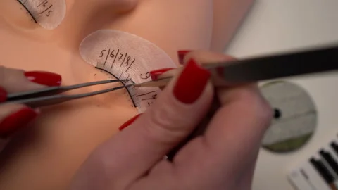 Basic training to build eyelashes on a silicone mannequin using tweezer and glue Stock Footage 235941162