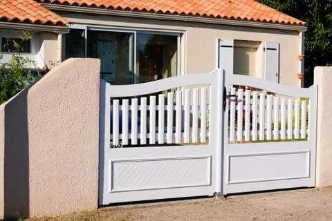 Basic white suburb pvc plastic house gate and slats street home Stock Photos