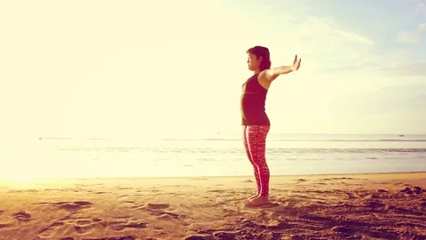 Basic Yoga of young Asian Thai woman on the beach during sunrise to re 스톡 동영상 78722956