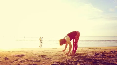 Basic Yoga of young Asian Thai woman on the beach during sunrise to re Stock Footage 78722972