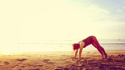 Basic Yoga of young Asian Thai woman on the beach during sunrise to re 스톡 동영상 78722995