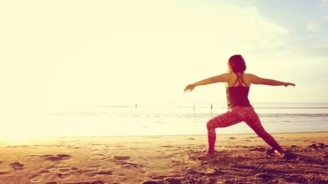 Basic Yoga of young Asian Thai woman on the beach during sunrise to re 스톡 동영상 78723011