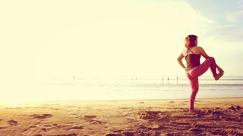 Basic Yoga of young Asian Thai woman on the beach during sunrise to re 스톡 동영상 78723020