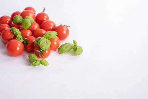 Basil and fresh tomatoes on a table Stock Photos