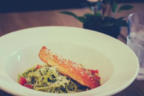 Basil, garlic and pine nuts blended into a pesto sauce, tossed with pasta Stock Photos