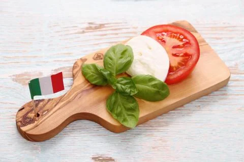 Basil leaf, mozzarella cheese, tomato slice and italy flag Stock Photos