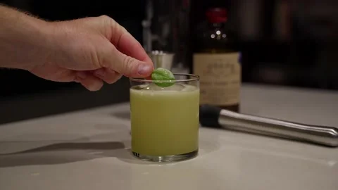 Basil leaf placed on basil gimlet cocktail Stock Footage 221591974