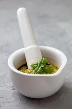 Basil pesto in a white mortar Stock Photos