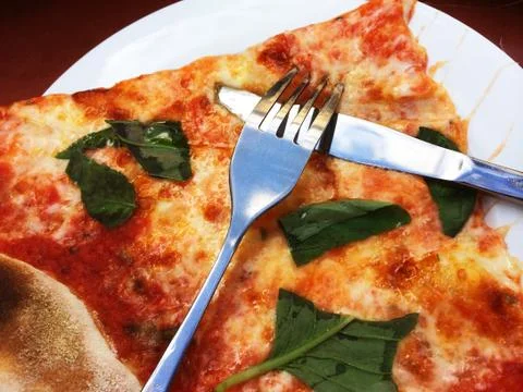 Basil Pizza Slice with Knife and Fork Stock Photos