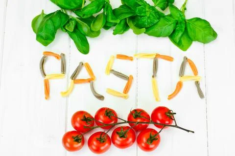 Basil, Red Cherry Tomato with Pasta on White Woody Background Stock Photos