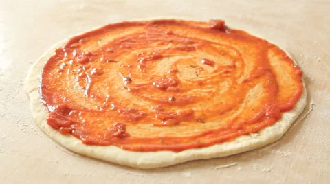 A basil slices fall on a rotating pizza on a black background. Stock Footage 65617608