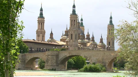 Basilica behind medieval stone bridge, framed by poplar trees Stock Footage 38707331