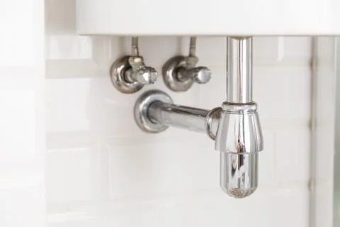 Basin siphon or sink drain in a bathroom, clean Stock Photos