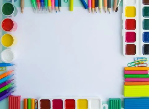 Bask to school. School items and stationery lie flat on a table on a white Stock Photos