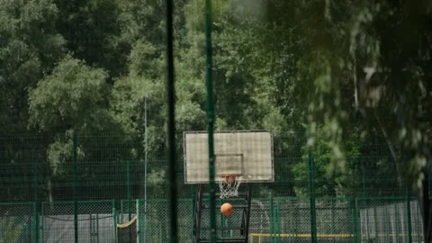 Basket ball falling trough the hoop. Basketball court outdoors Video stock 340321374