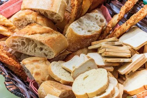 Basket of bread with different types of cheese on the table Stock Photos