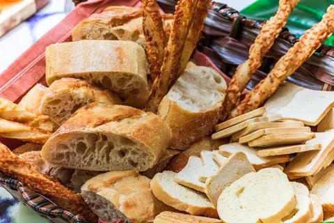 Basket of bread with different types of cheese on the table Stock Photos