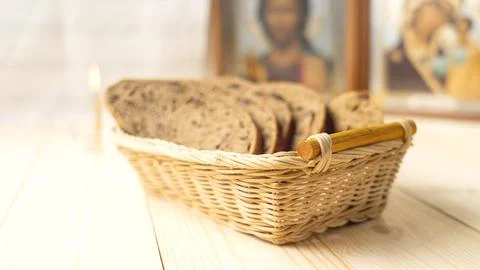A basket of bread is on a wooden table Stock Photos