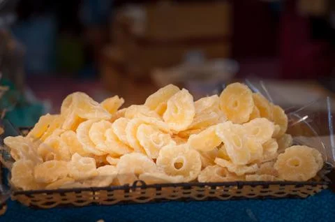 Basket of candied pineapple. Selective focus. Copy space. Stock Photos