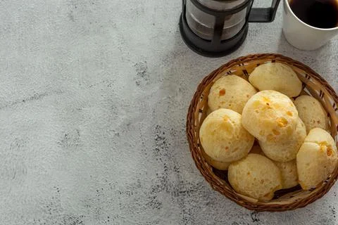 Basket with cheese breads, or 'pao de queijo, with coffee itens Stock Photos