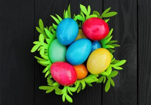 Basket with colored easter eggs. Easter holiday. Stock Photos