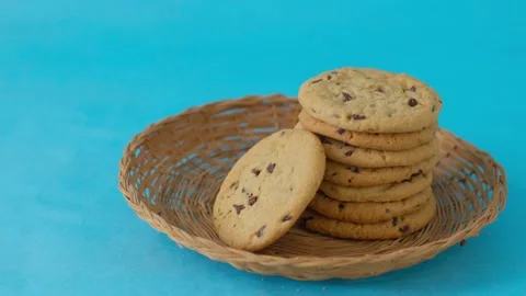 A basket of cookies sits on a blue table Video stock 310251704