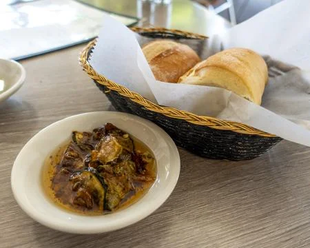 A basket of crispy artisan bread. Stock Photos