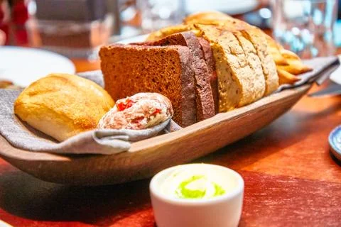Basket with different bread on the table in the restaurant Stock Photos