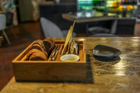 A basket with different types of bread in a restaurant Stock Photos