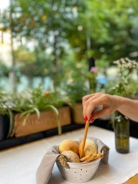 Basket with different types of fresh breads on the table. Stock Photos