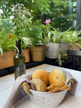 Basket with different types of fresh breads on the table. Stock Photos