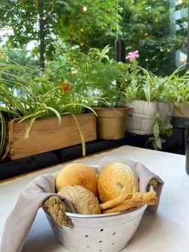 Basket with different types of fresh breads on the table. Stock Photos