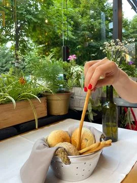 Basket with different types of fresh breads on the table. Stock Photos