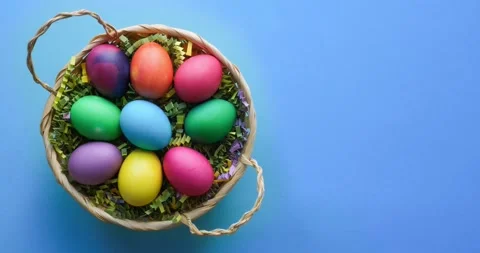 Basket with easter colored eggs on a blue background with a place for a text Stock Footage 235811630