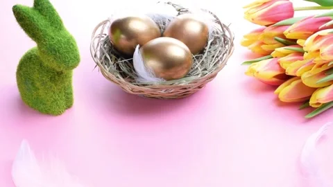 Basket easter decoration: Golden eggs in basket with spring tulips, white Stock Footage 148892407