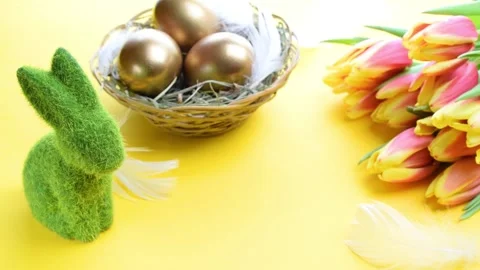 Basket easter decoration: Golden eggs in basket with spring tulips, white Stock Footage 150187451