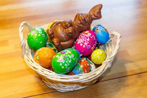 Basket with Easter eggs and Easter bunny on wooden table 写真素材