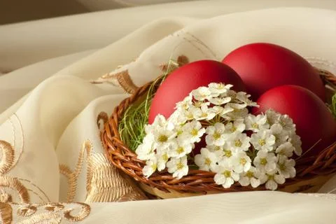 Basket with easter eggs and flowers Stock Photos